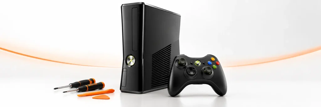 Console Xbox 360 noire avec une manette sans fil et des outils de précision sur fond clair